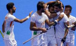 India's Varun Kumar (22) celebrates with his teammates after scoring 