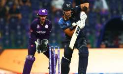 JJ Smit of Namibia plays a shot as Matthew Cross of Scotland looks on during the ICC Men's T20 Worl