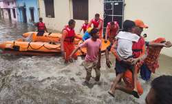 NDRF personnel rescue people stranded in floodwaters in