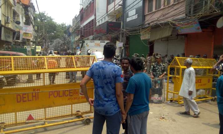 People stand near the temple on Tuesday.