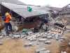 Villagers clear debris caused by an earthquake at Sajang