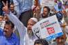 Kashmiri traders hold placards and raise slogans during a