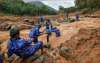 Rescue workers search for the bodies of missing persons