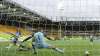 Brighton's Leandro Trossard, left, scores his side's