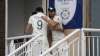 England's Mark Wood, right, hugs to congratulate teammate