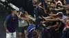 Australia's Nick Kyrgios gives his racquet to fans after