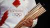 Greek singer Sakis Rouvas wears the uniform of the torch