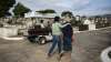 Relatives accompany the coffin that contains the remains of