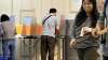 Voters cast their ballots at a polling station in Tokyo