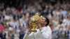 Serbia's Novak Djokovic kisses the winners trophy as he