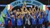 Italy's team celebrates with the trophy on the podium after