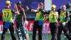 Australia's Adam Zampa, centre, is congratulated by teammates after taking the wicket of Bangladesh