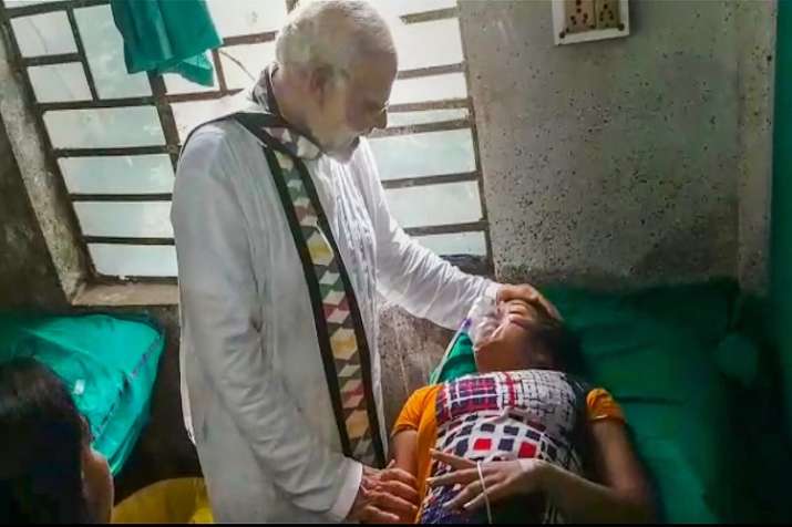 Prime Minister Narendra Modi visits a woman, who was