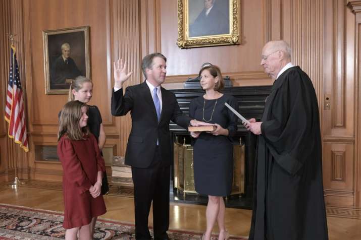 Wife Ashley Kavanaugh held the family Bible. Justice