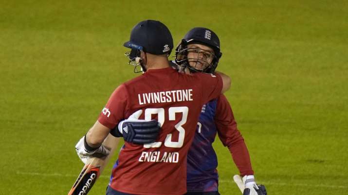England's Sam Curran, right, hugs teammate England's Liam